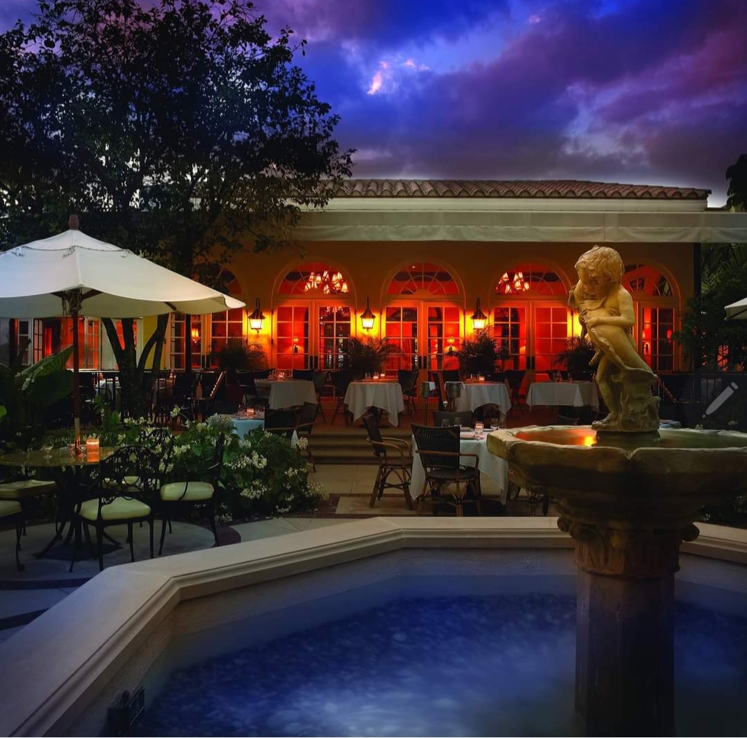 Image of Cafe Boulud on Palm Beach Island restaurant patio with fountain.